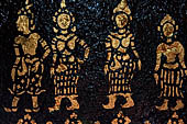 Wat Xieng Thong temple in Luang Prabang, Laos. Detail of the  intricate gold stencilling on black lacquer that decorate the walls of the sim. 